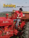 A man sitting on top of a red tractor.