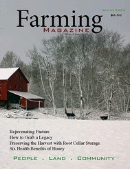 A farm with snow and trees in the background.